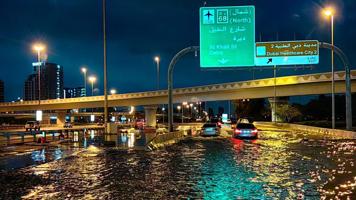 Motorisits drive along a flooded street following heavy rains in Dubai last week. Photo: AFP