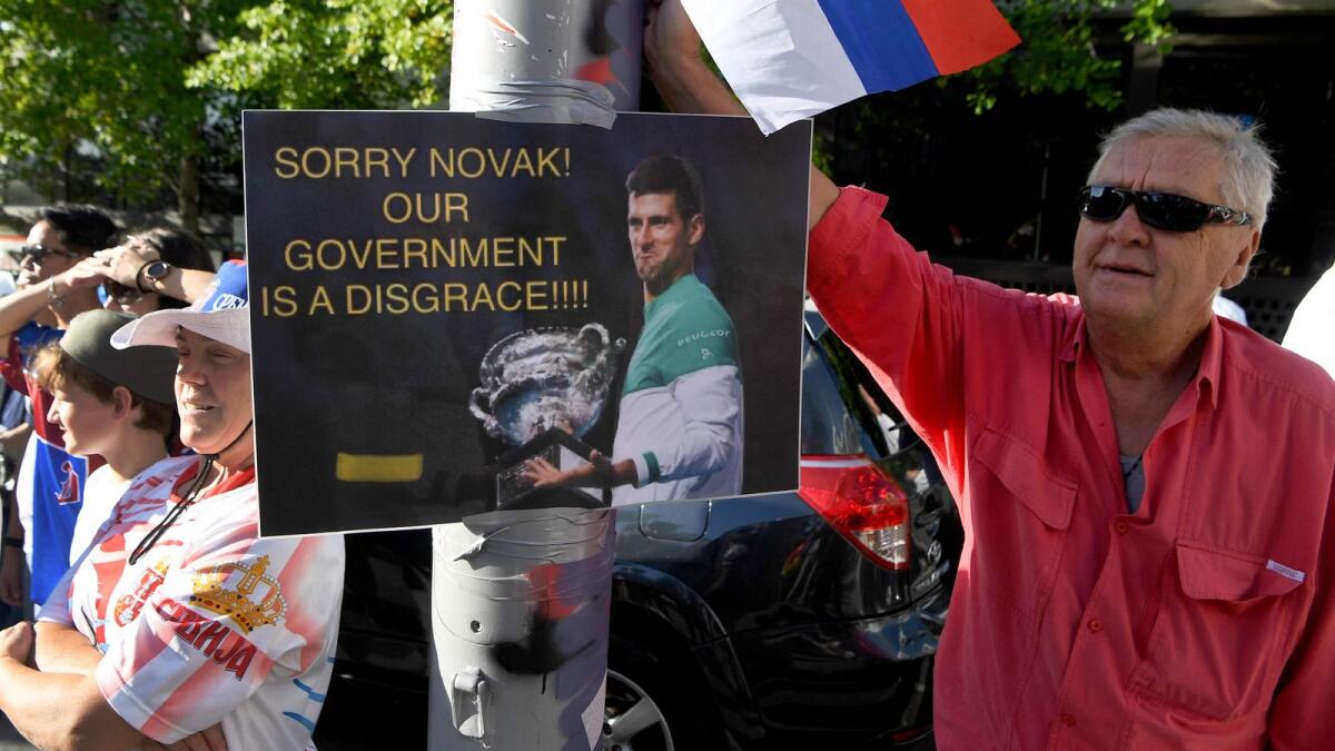 Members of the local Serbian community rally outside a government detention centre where Novak Djokovic is staying in Melbourne. (AFP)