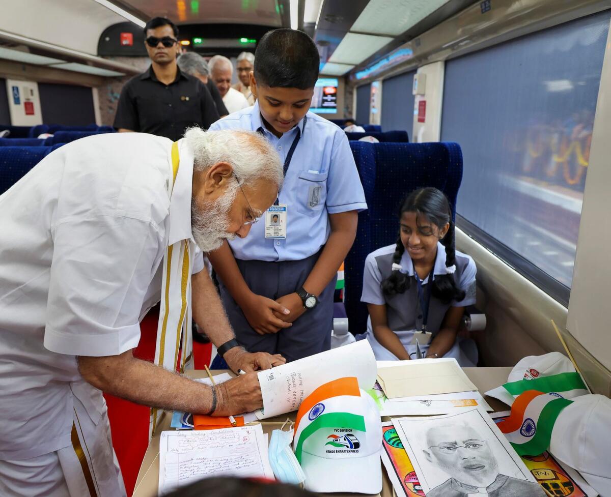 Prime Minister Narendra Modi interacts with students in Kerala’s first Vande Bharat Express train at Thiruvananthapuram Central Station on Tuesday. — PTI