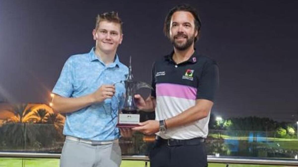 James Baxter (left) receiving the Sharjah Golf &amp; Shooting Club Men's Open Trophy from Sam MacLaren, (right) Director of Golf.- Supplied photo