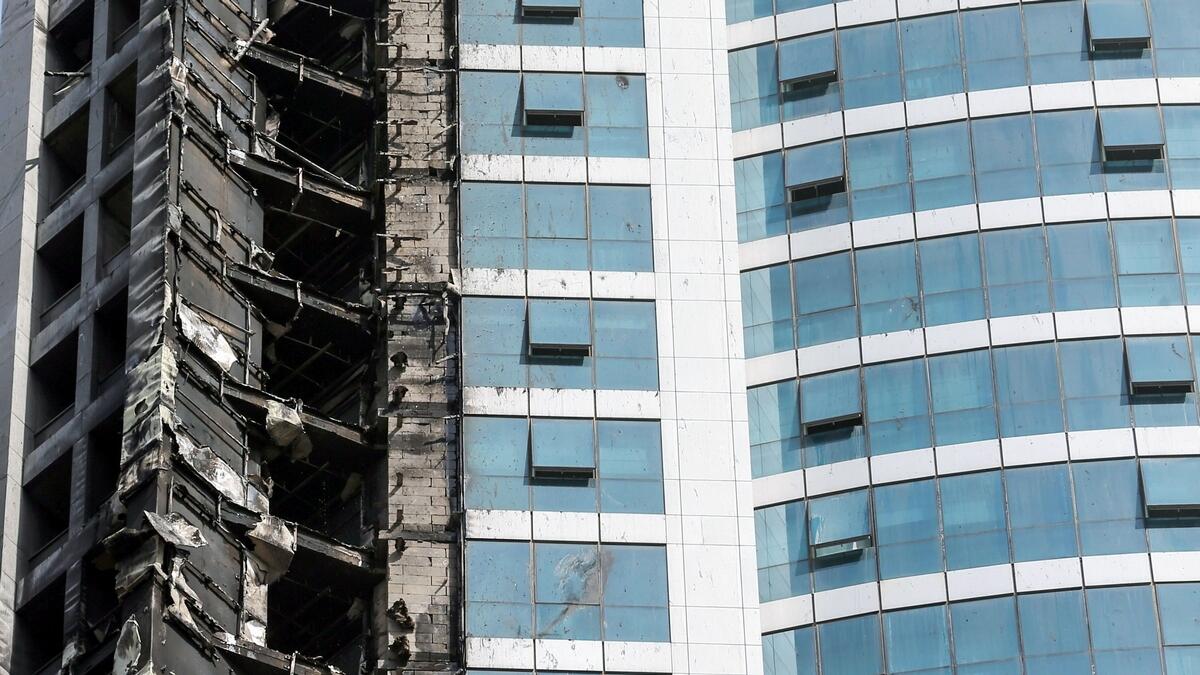 A picture taken on August 4, 2017 shows a close-up view of fire damages to 'The Torch', one of the tallest towers in Dubai, after a fire blaze ripped through it early in the morning.