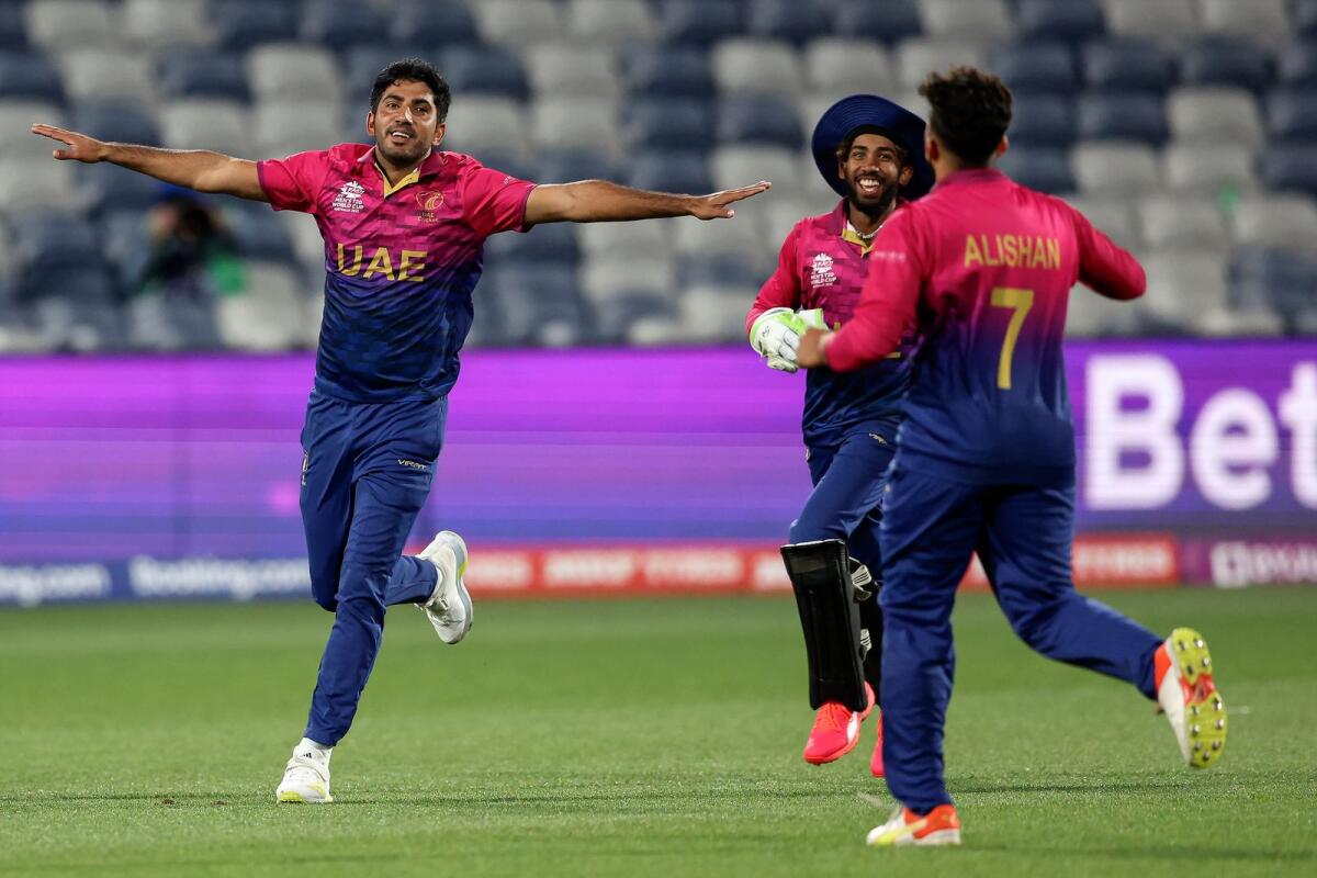 The UAE's Junaid Siddique (left) celebrates the wicket of Namibia's Stephan Baard with teammates during the ICC T20 World Cup match in Geelong on October 20. — AFP