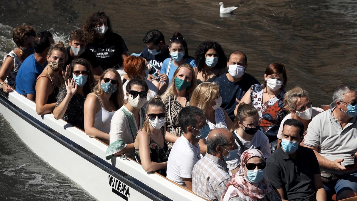 People wear protective face masks as they enjoy a boat trip on a canal in central Bruges, following the spread of the coronavirus disease (Covid -19), Belgium. Photo: Reuters