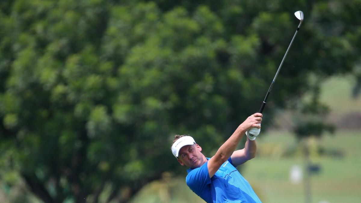 Ian Poulter of England plays an approach shot on day one of the EurAsia Cup golf tournament in Kuala Lumpur. 