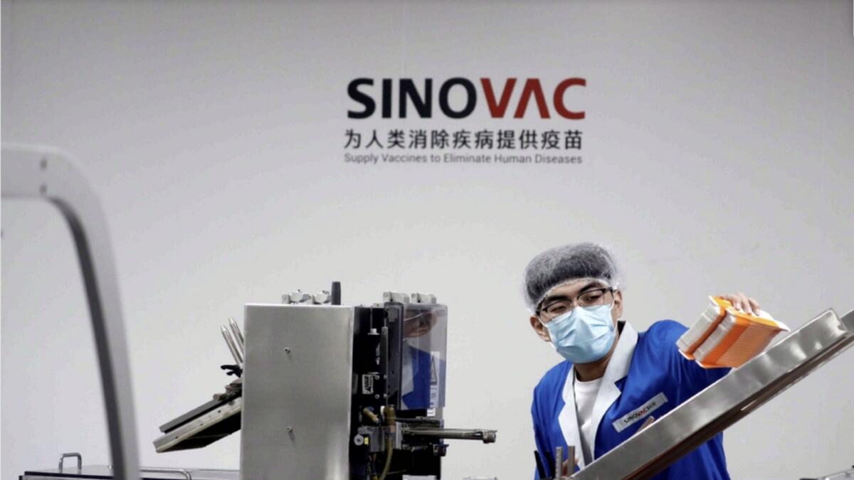 A man works in the packaging facility of Chinese vaccine maker Sinovac Biotech in Beijing.