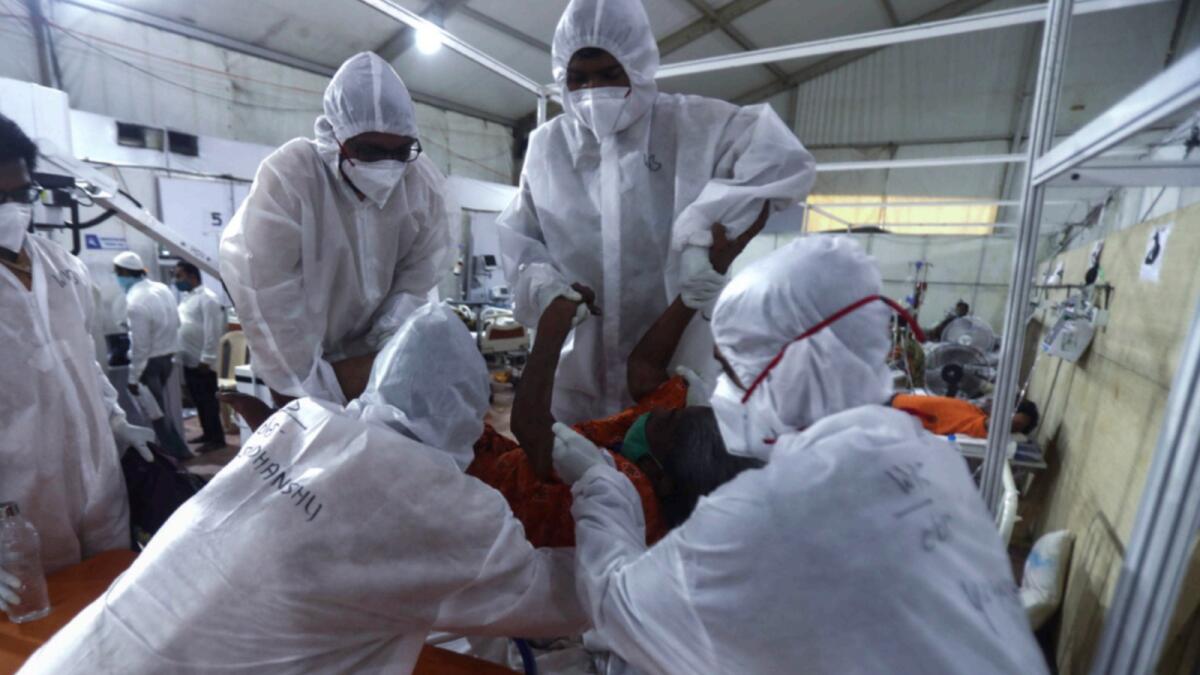 Health workers attend to a patient at the BKC jumbo field hospital in Mumbai. — AP file