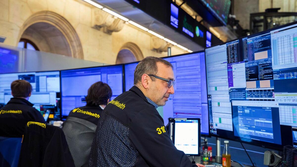 New York Stock Exchange traders work on the floor. – AP