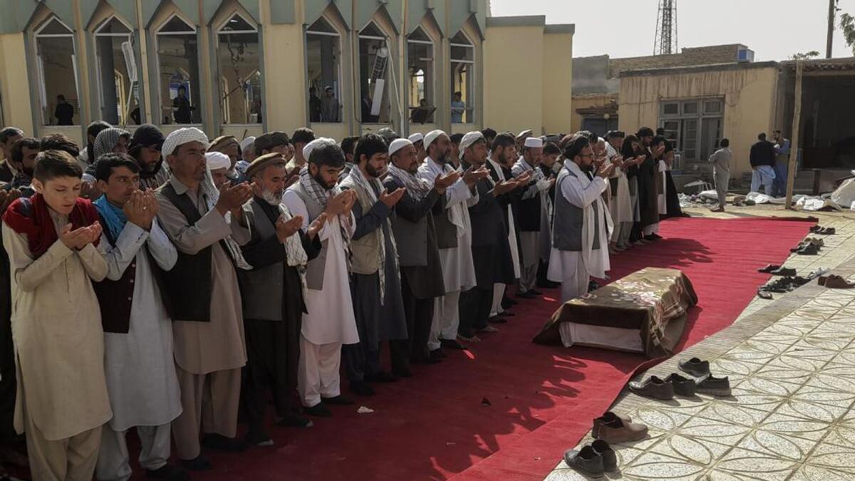 Relatives pray during a funeral ceremony for victims of Friday's suicide attack on a mosque. Photo: AP