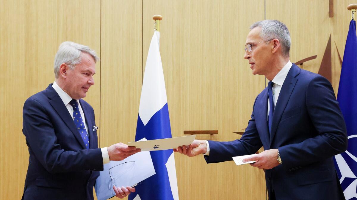 Nato Secretary-General Jens Stoltenberg (R) hands over Finland's accession to Nato documents to Finnish Foreign Affairs Minister Pekka Haavisto, during a joining ceremony at the Nato headquarters in Brussels on April 4.  — AFP