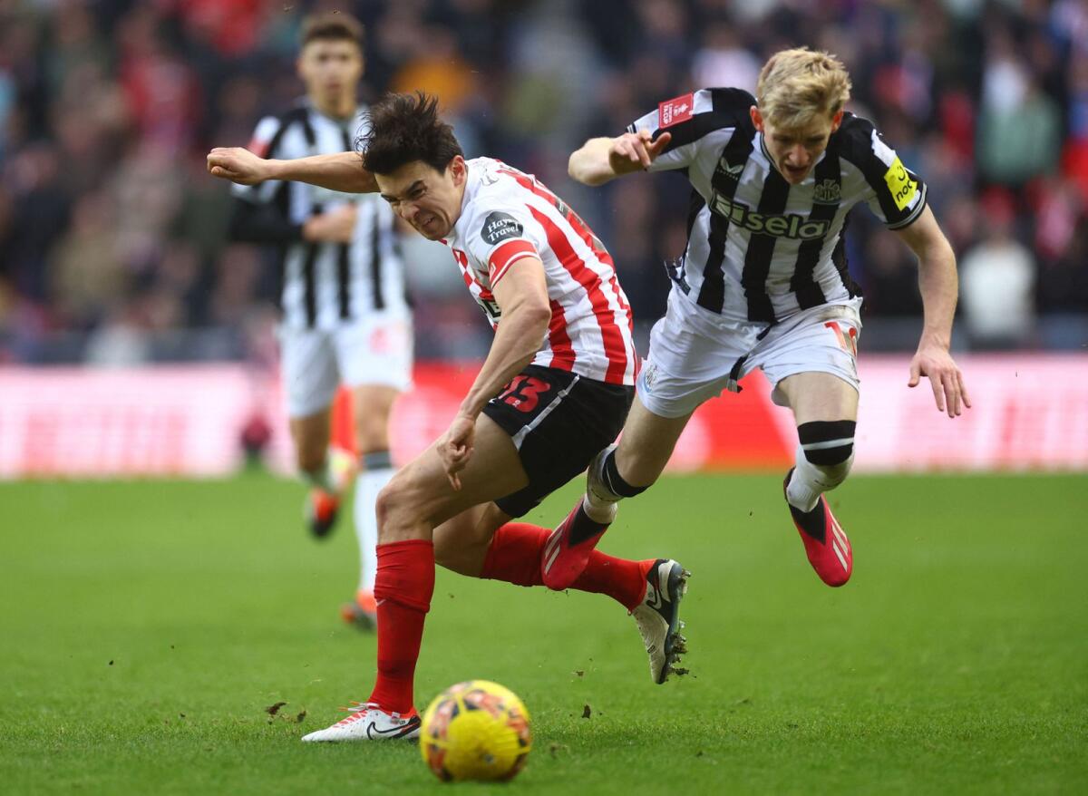 Newcastle United's Anthony Gordon in action with Sunderland's Luke O'Nien. - Reuters