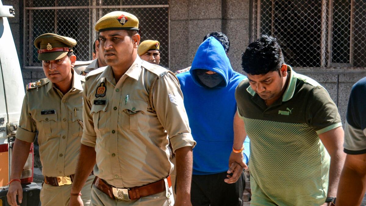 Singer Samar Singh, an accused in the death case of actor Akanksha Dubey, being arrested by police personnel in Ghaziabad on Friday. — PTI