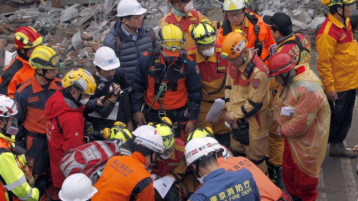 Rescuers from Japan join the searching operation at an apartment building collapsed after a strong earthquake in Hualien County, eastern Taiwan.-AP 