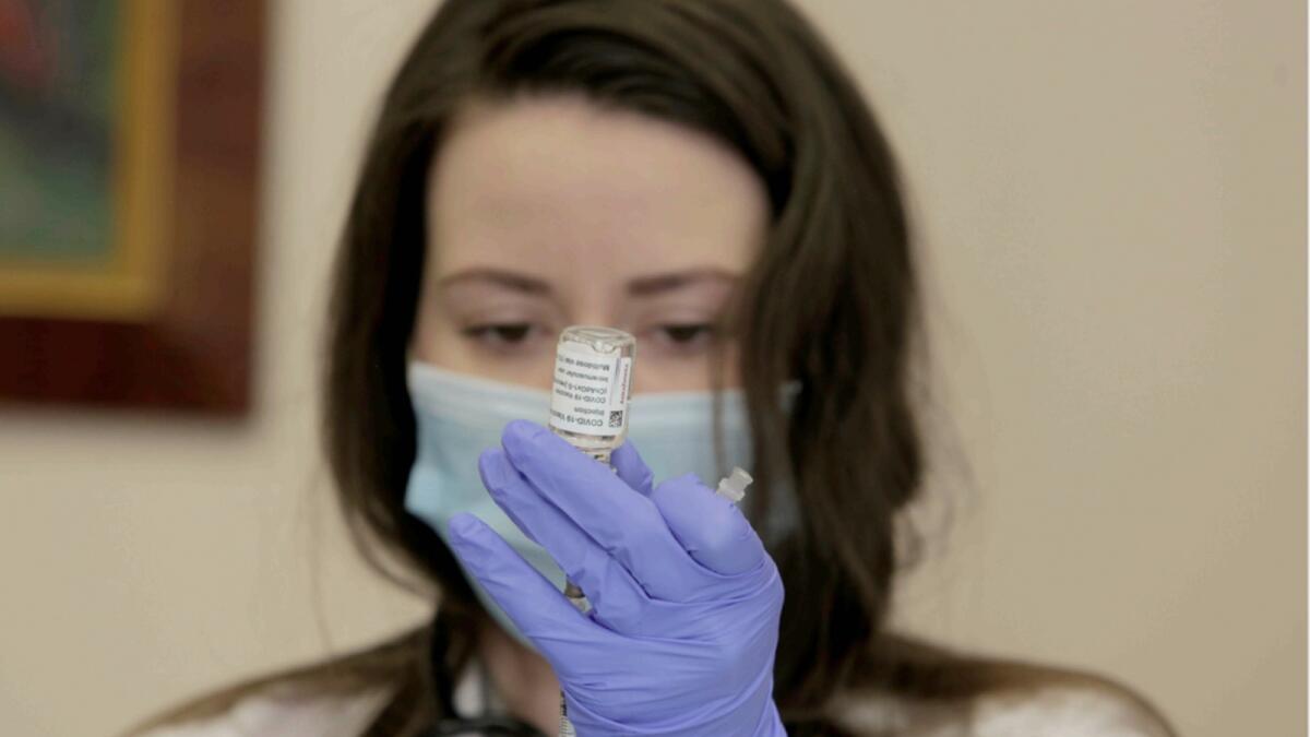 A medical worker prepares a dose of the Oxford-AstraZeneca vaccine in Bulgaria. — AP