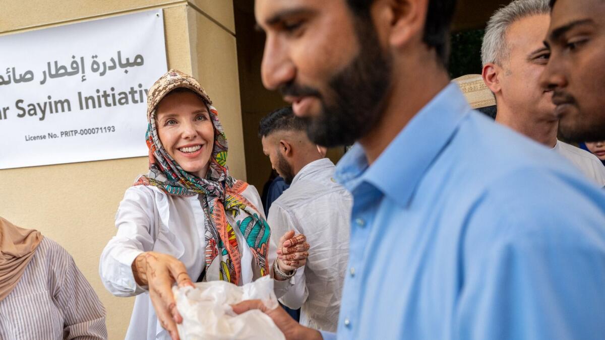 Kelly Harvarde hands out packets of food on the first day of Ramadan. (KT Photos: Shihab)