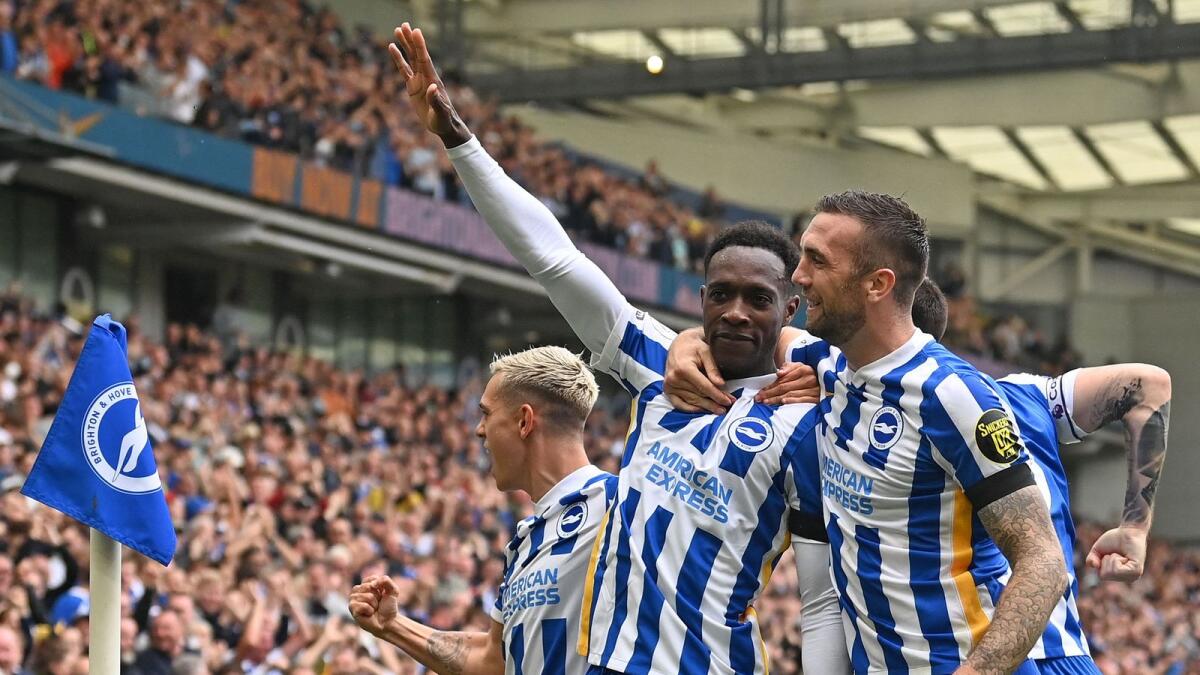 Brighton's English striker Danny Welbeck celebrates his goal with teammates. — AFP