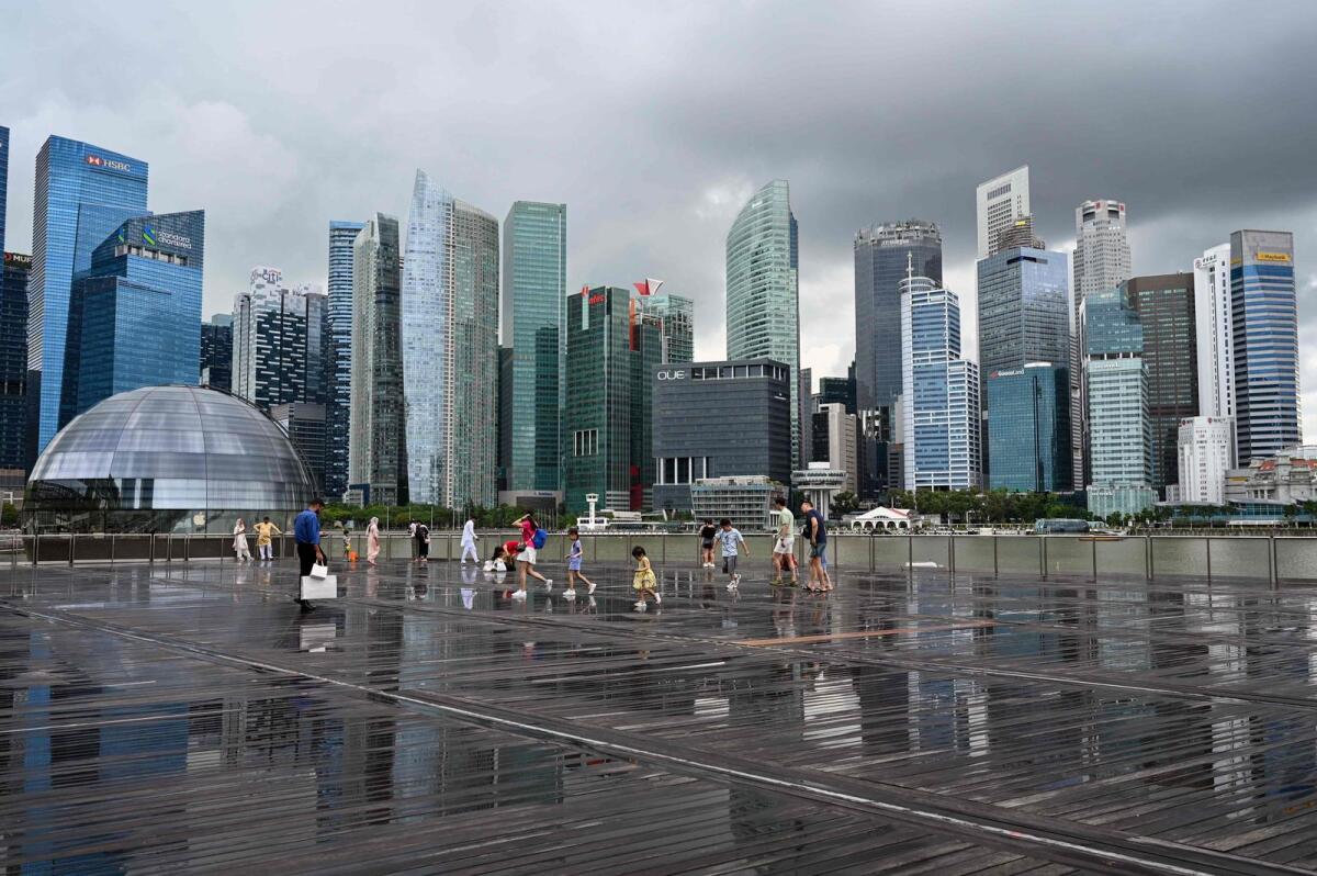 People gather on the boardwalk at Marina Bay in Singapore on January 9, 2024. — AFP