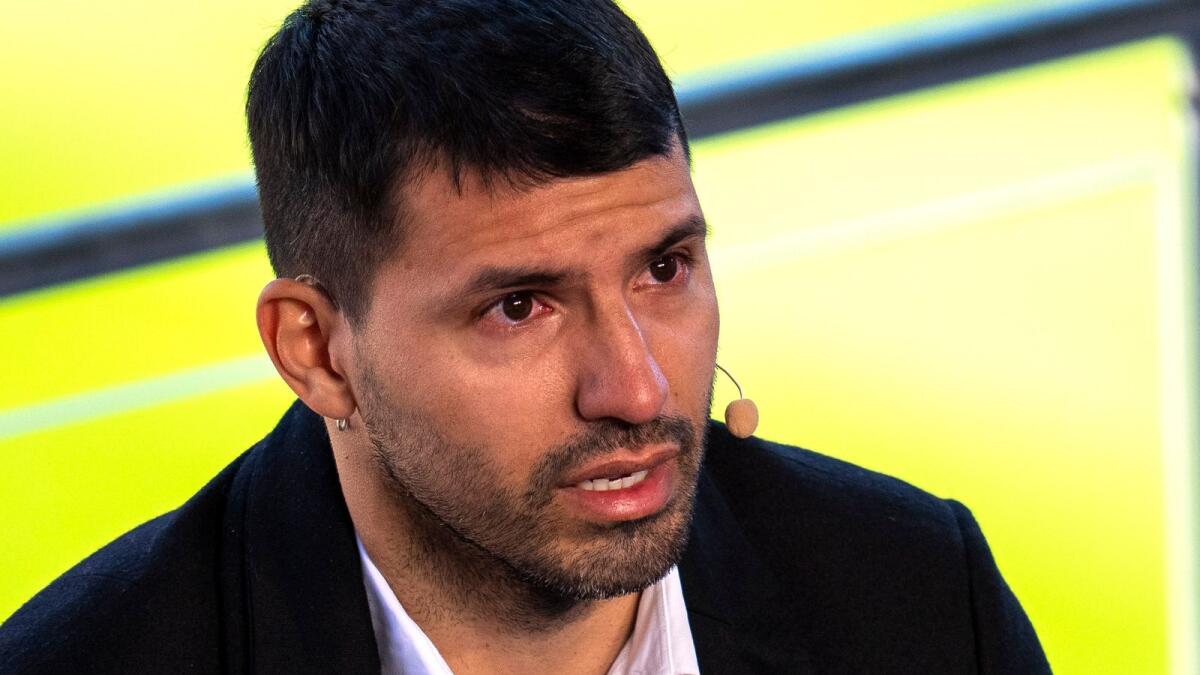 Barcelona striker Sergio Aguero cries during a press conference at the Camp Nou in Barcelona on Wednesday. — AP