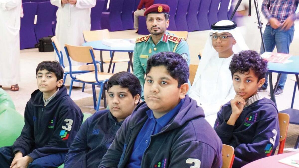 Brigadier Saif Al Zari Al Shamsi and school children attend a child safety workshop during the launch of the third Child Safety Campaign in Sharjah. 