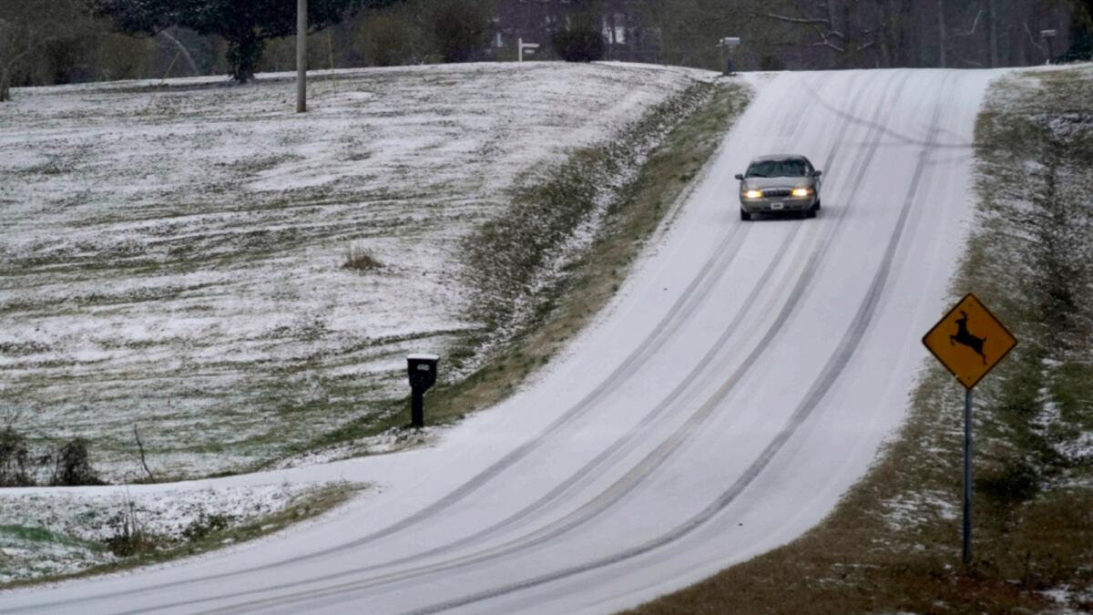 A driver navigates an icy road as a winter storm moves through the area in Orange County near Hillsborough, N.C. — AP