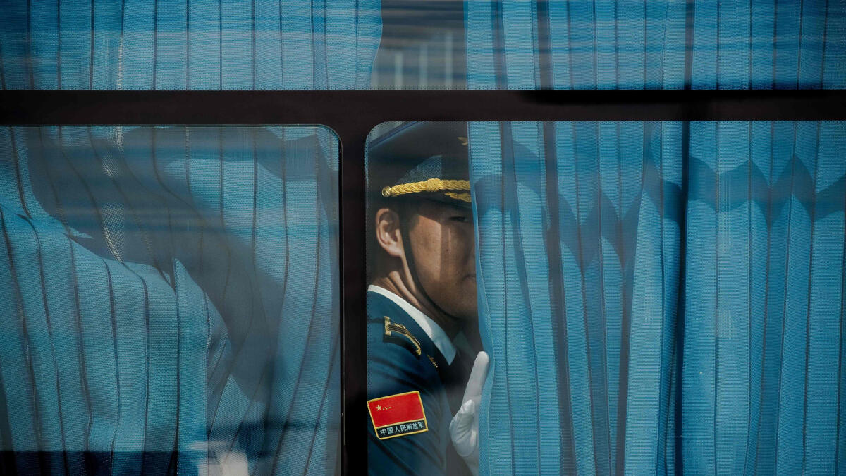 A honour guard looks out from a bus ahead of US President Barack Obama (not pictured) arrival at Hangzhou Xiaoshan International Airport in Hangzhou on September 3, 2016. World leaders are gathering in Hangzhou for the 11th G20 Leaders Summit from September 4 to 5. / AFP