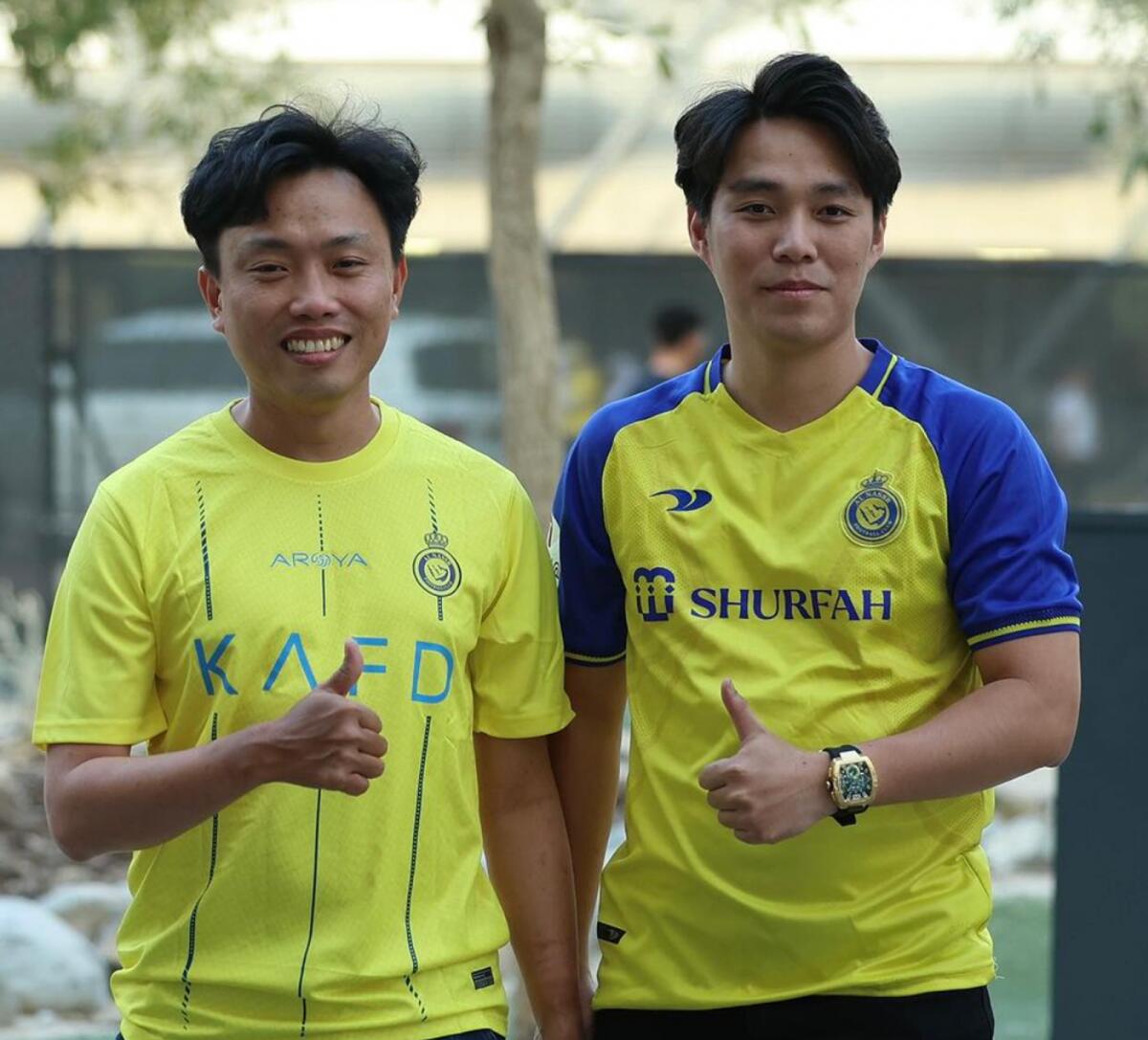 Vietnamese fan Pong Wang (right) with his friend after receiving tickets for the match in Al Ain. — Al Nassr Instagram
