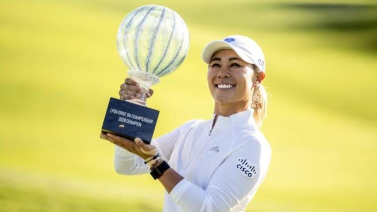 Danielle Kang of the United States holes up the trophy after winning the tournament. (Reuters)