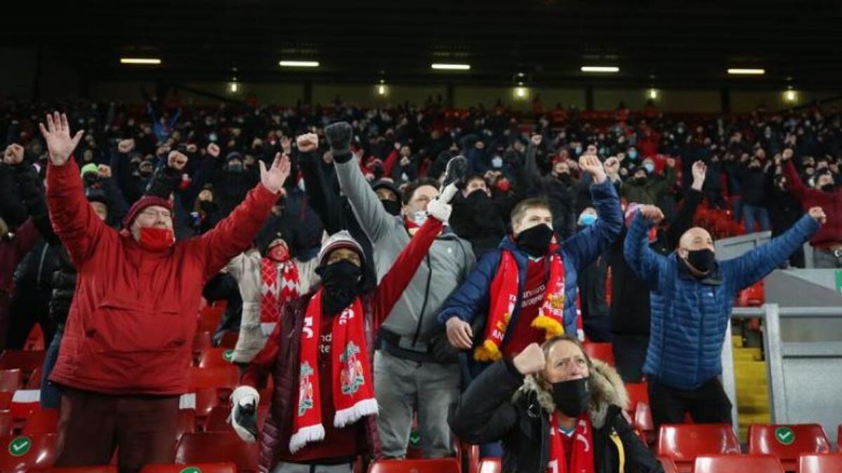 Liverpool fans in the stands celebrate during the match against Wolverhampton Wanderers on Sunday. (Reuters)