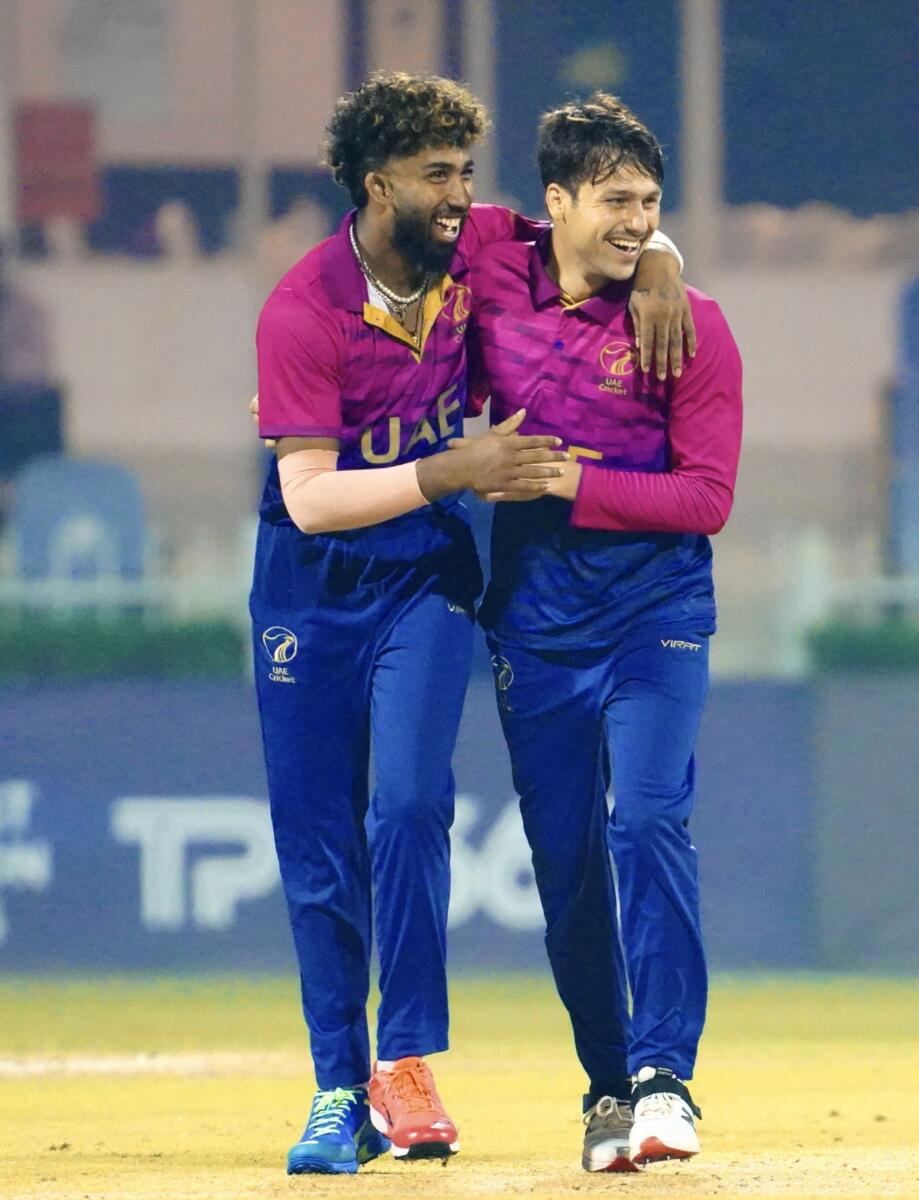 Muhammad Jawadullah celebrates a wicket with Vriitya Aravind. — Emirates Cricket Board