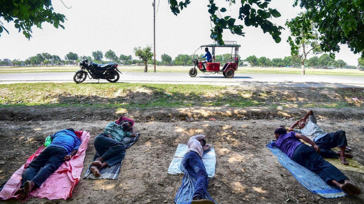 Men rest beneath a tree during a hot summer day in Prayagraj on May 11, 2023. Scientists say global warming is exacerbating adverse weather, with many countries experiencing deadly heatwaves and temperatures hitting records across Southeast and South Asia in recent weeks.  — AFP