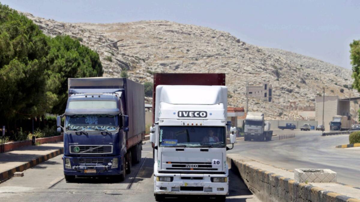 A convoy transporting humanitarian aid crosses into Syria from Turkey through the Bab Al Hawa border crossing. — AFP