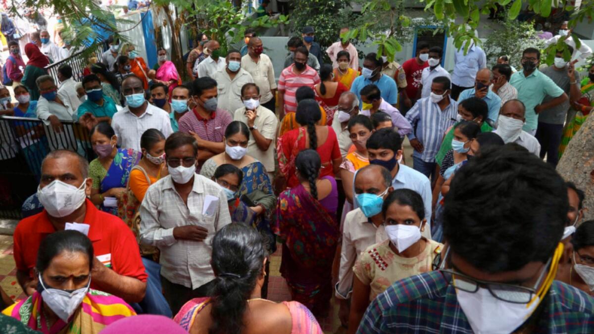 People wait to receive the second dose of Covid-19 vaccine at a public health centre in Hyderabad. — AP