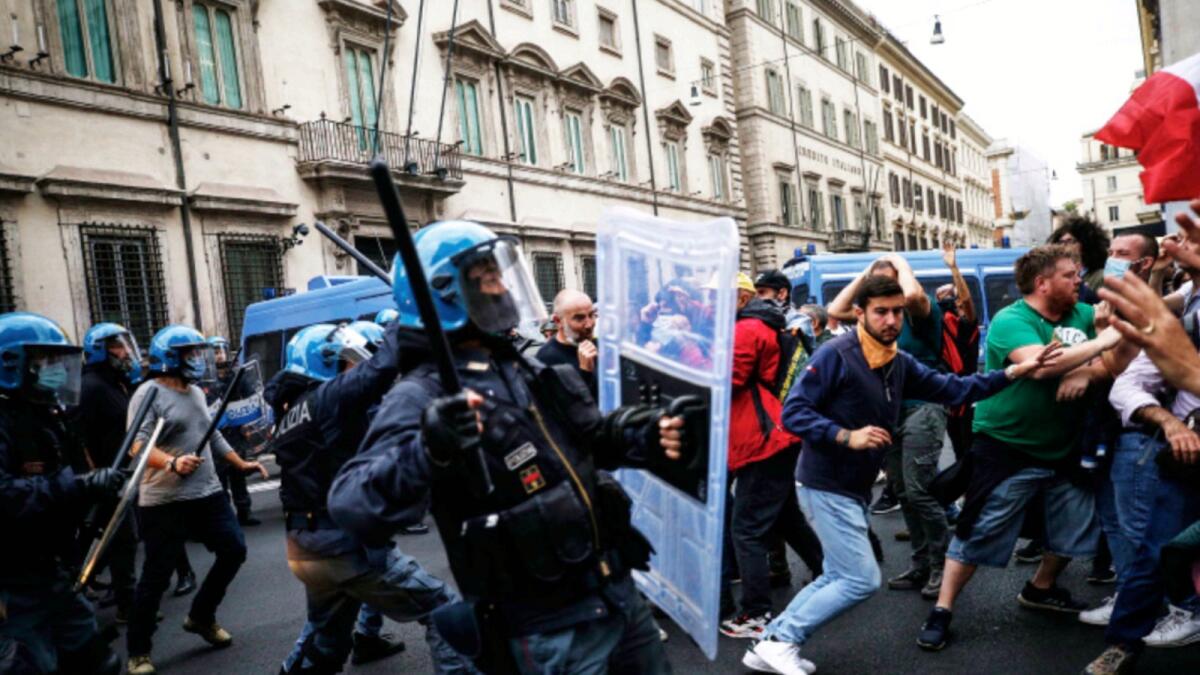 Police clashes with demonstrators during a protest against Covid-19 health pass in Rome. — AP