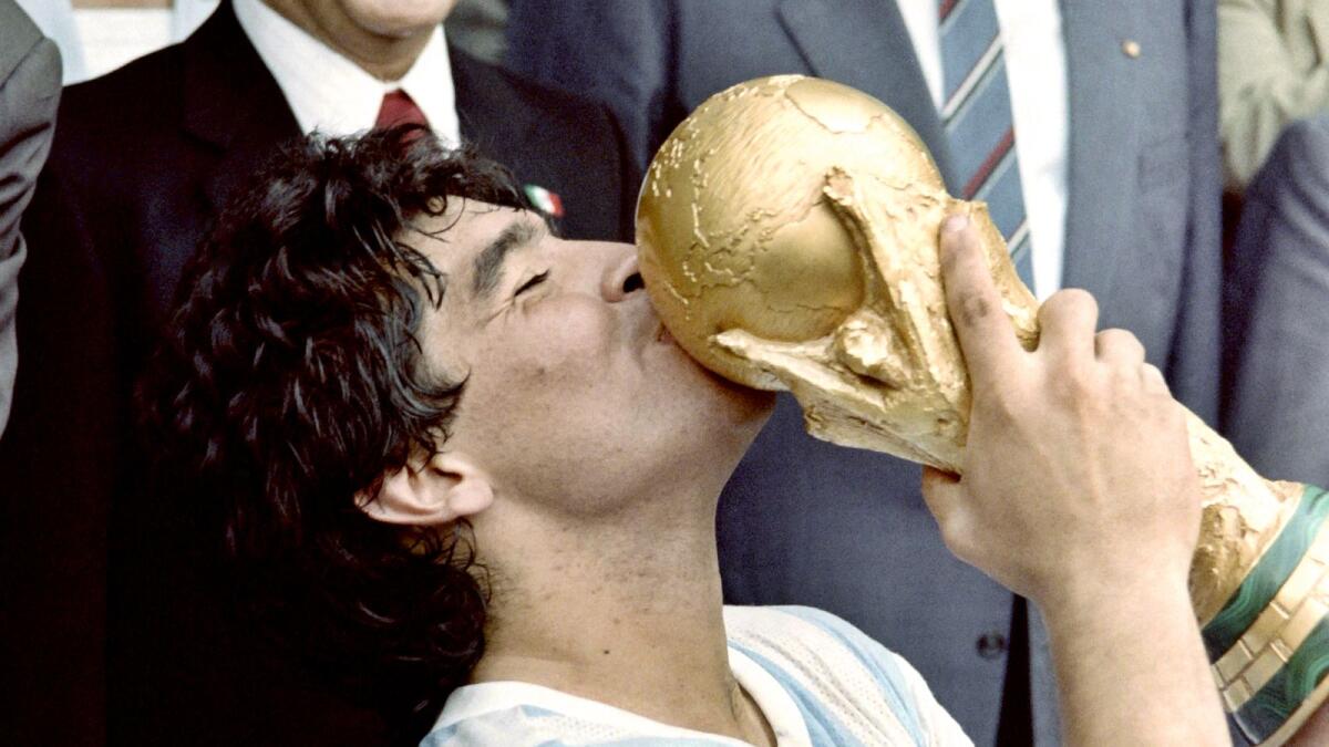 Diego Maradona celebrates his crowning glory: lifting the 1986 World Cup.
