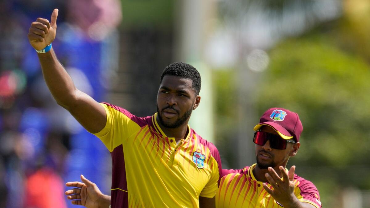 West Indies' Obed McCoy (left) celebrates after dismissing India's Ravindra Jadeja during the second T20 match at St. Kitts and Nevis on Monday. — AP