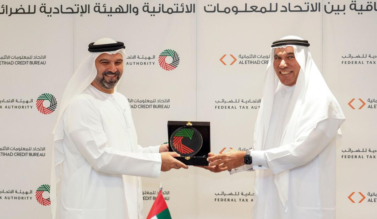 The agreement was signed by Khalid Ali Al Bustani, director-general of the FTA, and Marwan Ahmad Lutfi, director-general of Etihad Credit Bureau. — Supplied photo