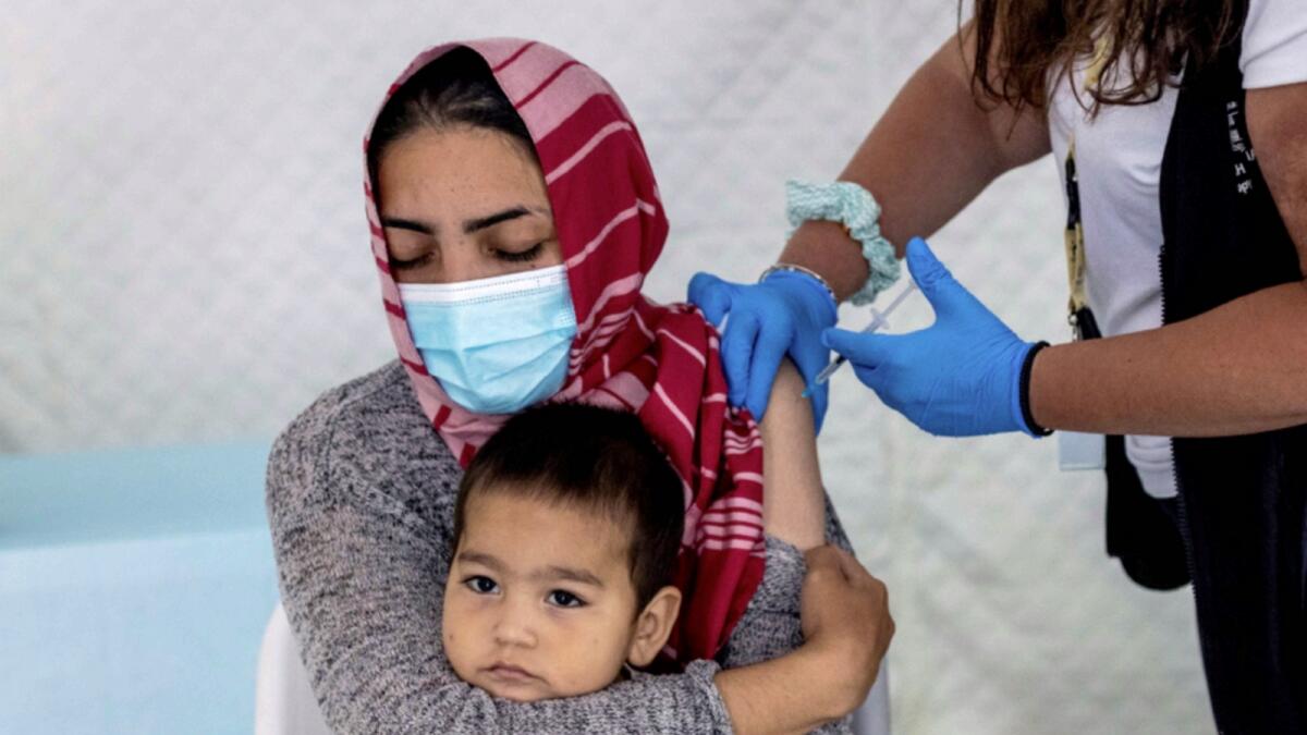 A migrant receives vaccine in Greece. — Reuters file