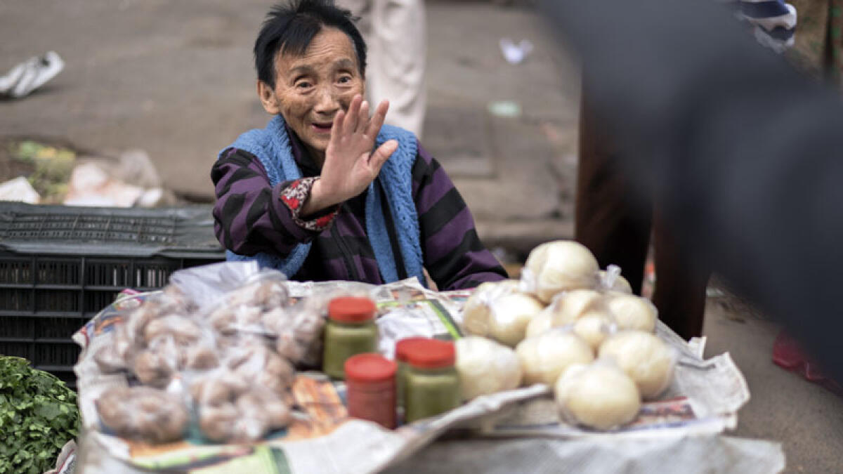 A Chinese Indian seller of sauce and steamed bread at Tiretta Bazaar