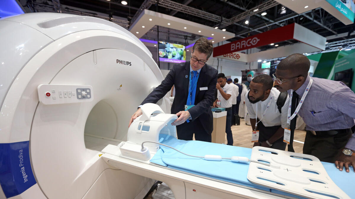 Visitors check the CT Scan on display during the Arab Health 2018 at the Dubai World Trade Centre.   Photo by Dhes Handumon