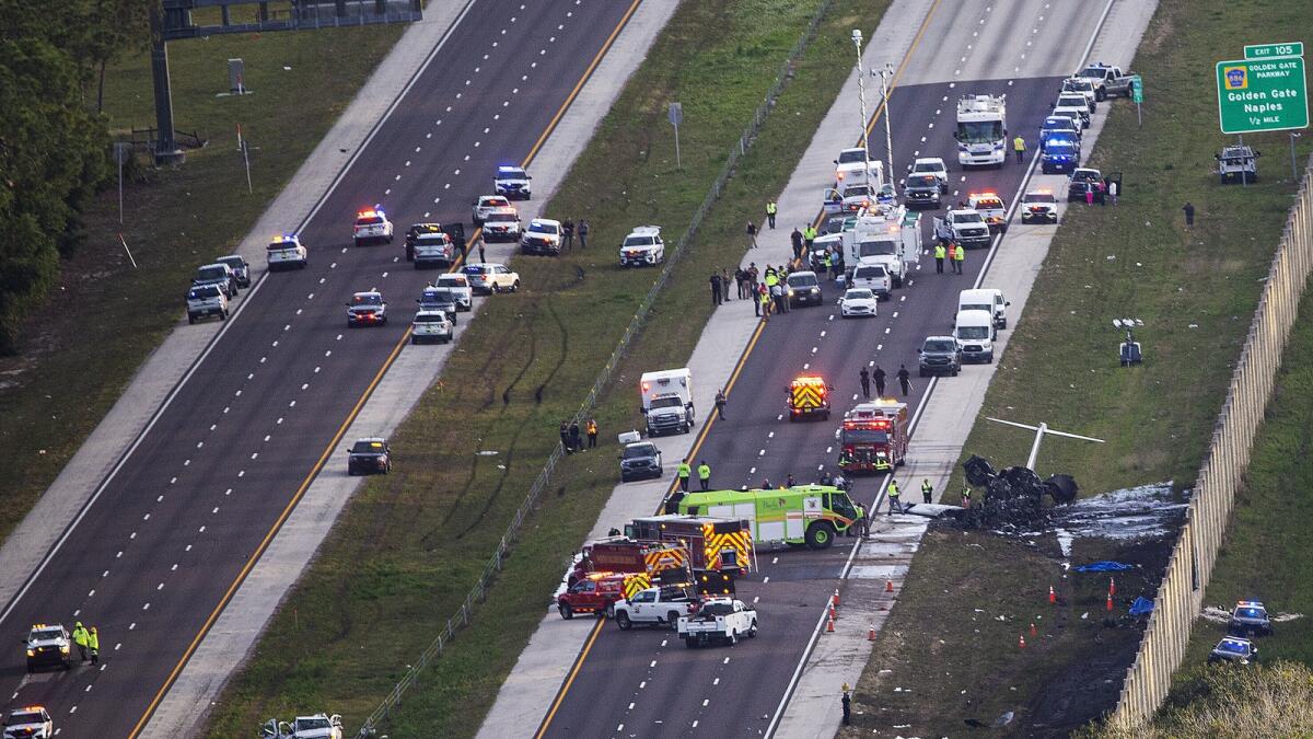 Emergency officials work the scene of a small plane crash on Interstate 75 in Naples. — AP