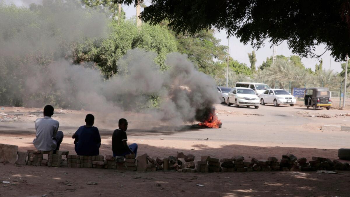 Protesters burn tires in Khartoum, Sudan. — AP