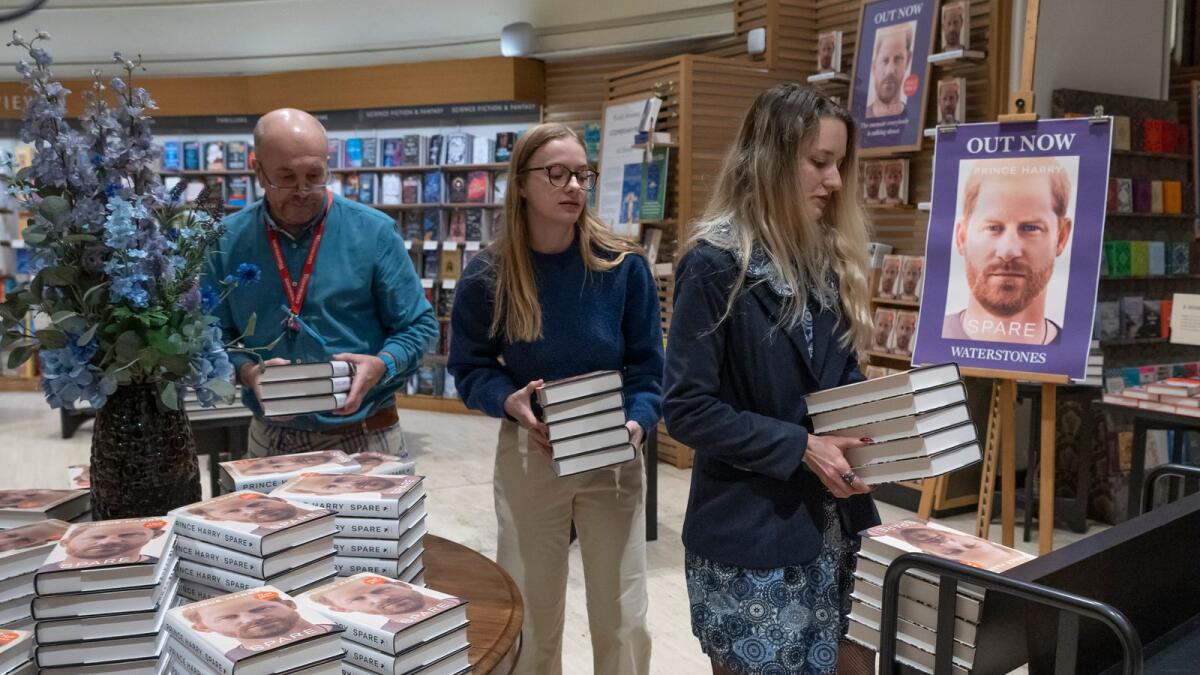Members of staff place the copies of the new book by Prince Harry called 'Spare' at a book store in London on Tuesday. — AP