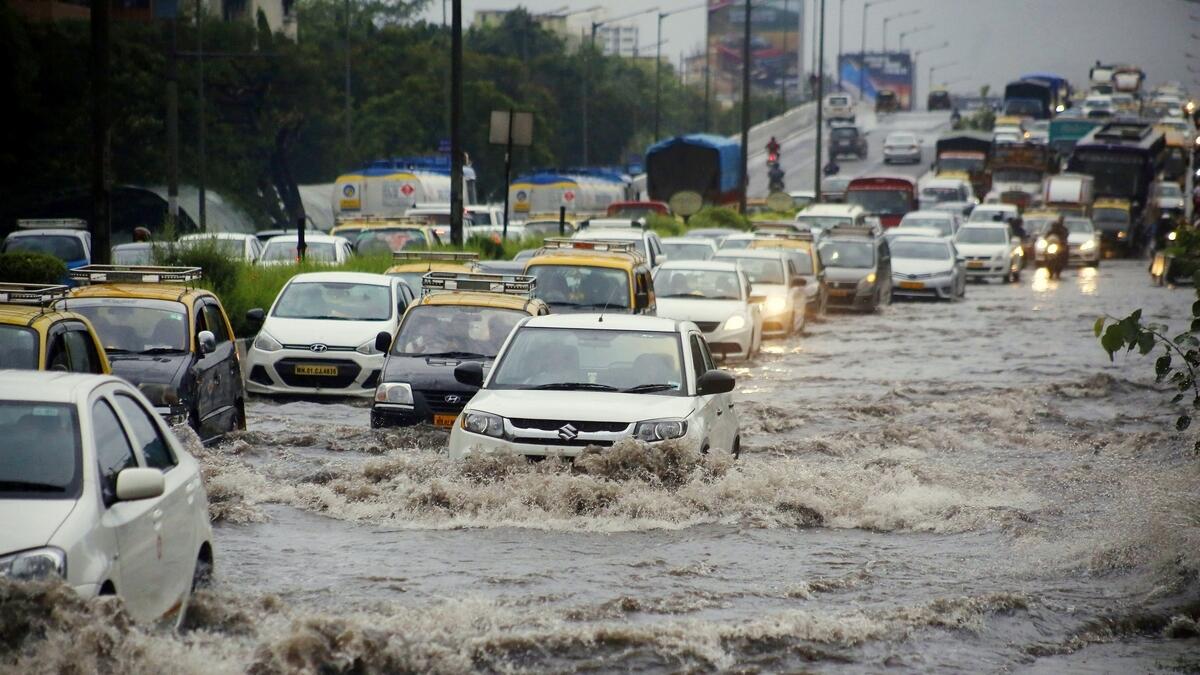 Vehicles move on flooded Western Express highway after heavy rainfall near Bandra in Mumbai.-ANI 