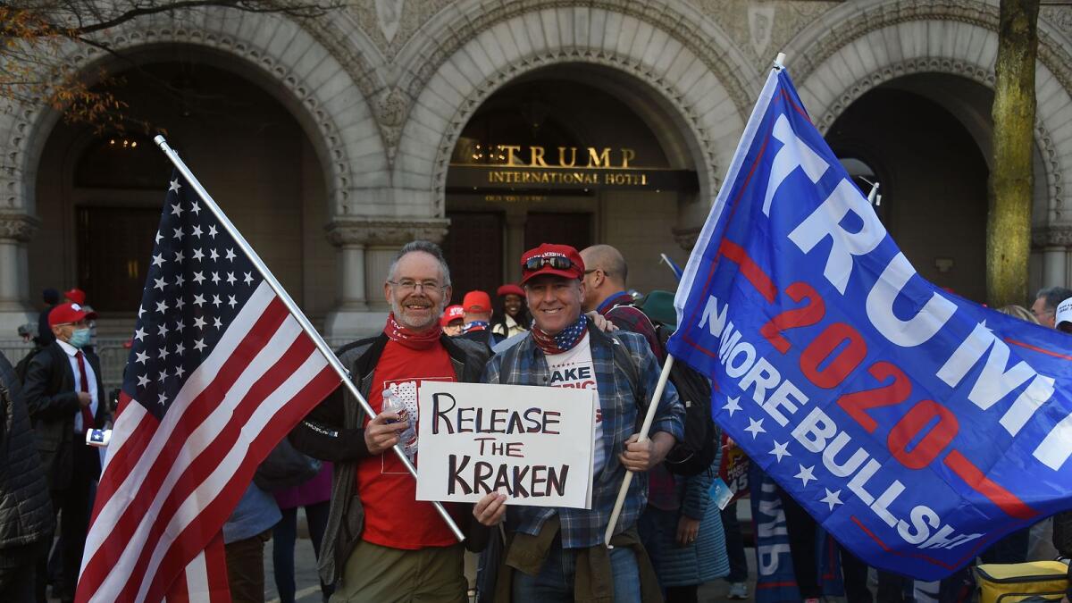Supporters of US President Donald Trump march past the Trump International Hotel in Washington, DC, on November 14, 2020. AFP