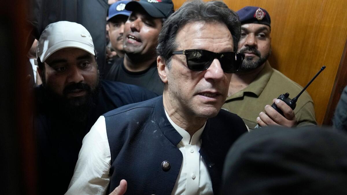 Former Pakistani Prime Minister Imran Khan leaves court after an appearance in Lahore on May 19. — AP file