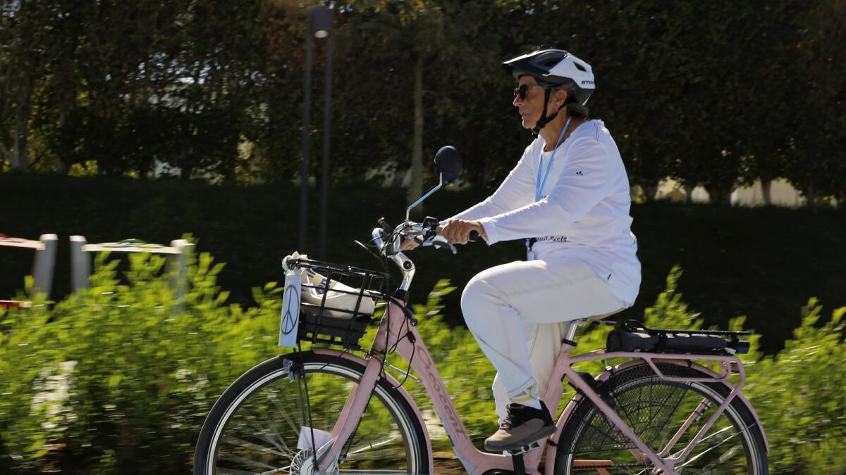 Dorothee Hildebrandt rides her bike to the UN climate summit COP27 in Sharm El Sheikh, Egypt, on Saturday. — AP