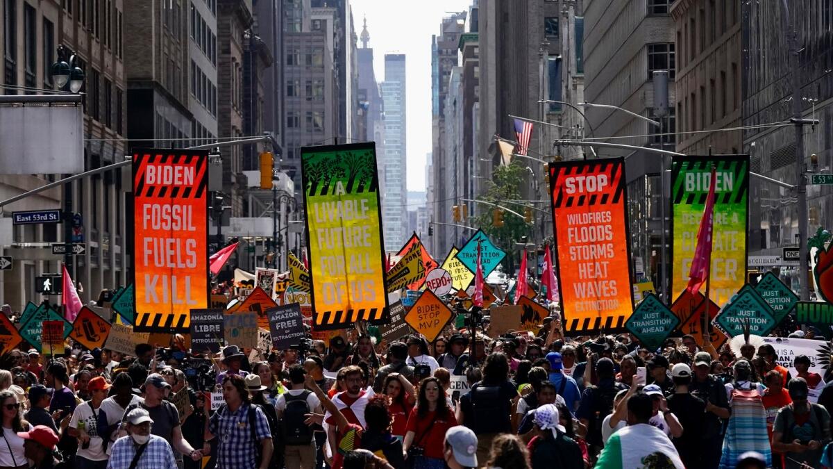 Climate activists march on Madison Avenue while protesting energy policy and the use of fossil fuels, in New York, Sunday, Sept. 17, 2023. (AP Photo/Bryan Woolston)