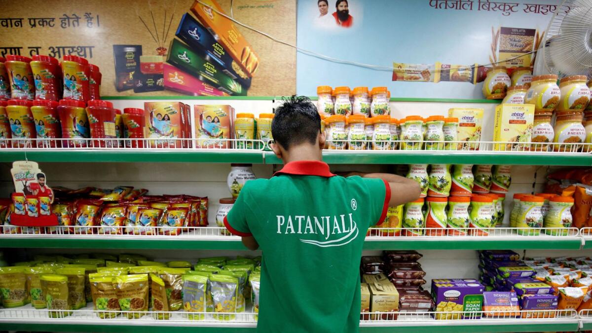A worker arranges consumable goods inside a Patanjali store in Ahmedabad. — Reuters
