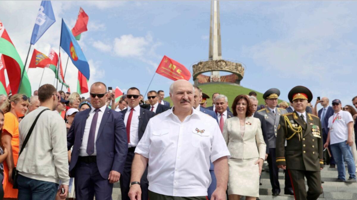 Belarusian President Alexander Lukashenko, center, takes part in a wreath ceremony at the Mound of Glory Memorial during celebration of the  Belarusian Independence Day. — AP