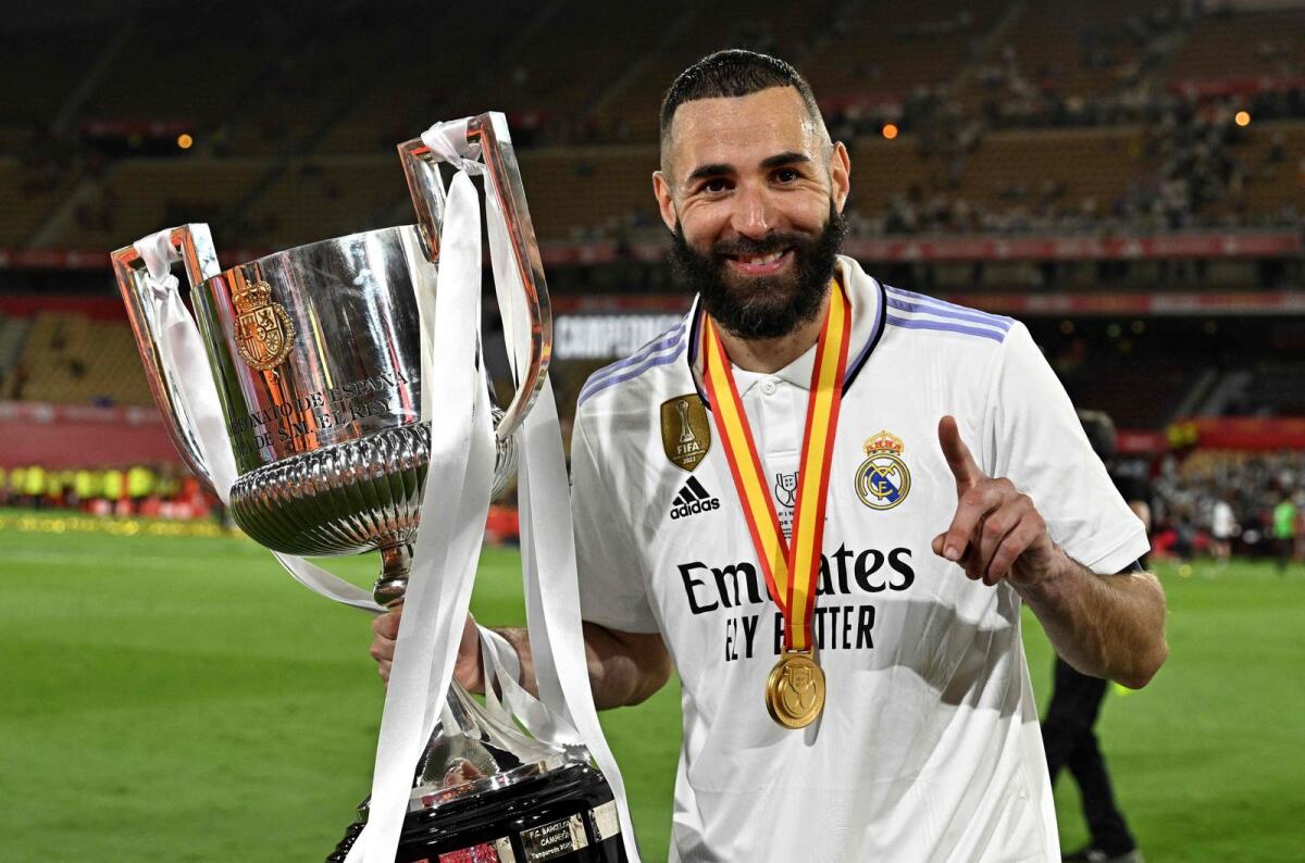 Real Madrid's French forward Karim Benzema holds the King's Cup trophy. — AFP