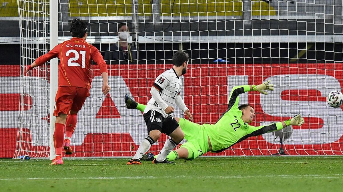 North Macedonia's Eljif Elmas (left) scores the decisive second goal for his side against Germany's keeper Marc-Andre ter Stegen during the World Cup 2022 group J qualifying match. — AP